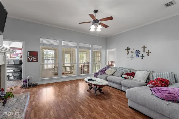 a living room with furniture and wooden floor