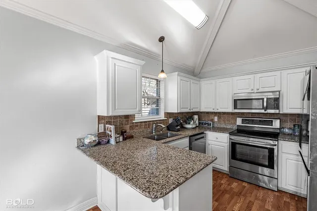 a kitchen with stainless steel appliances granite countertop a sink stove and refrigerator