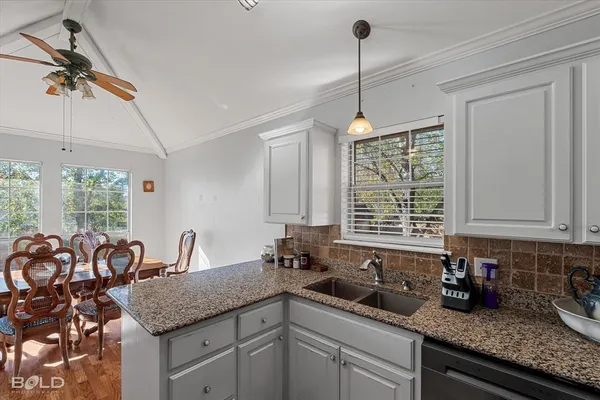 a kitchen with counter space windows and cabinets