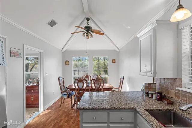 a view of dining table chairs and chandelier
