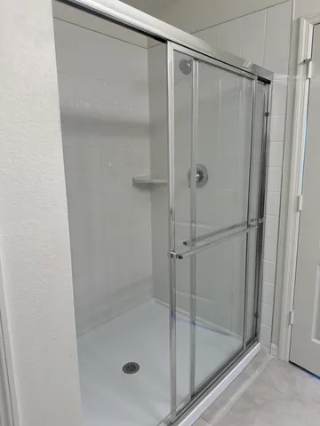 a bathroom with a glass shower door