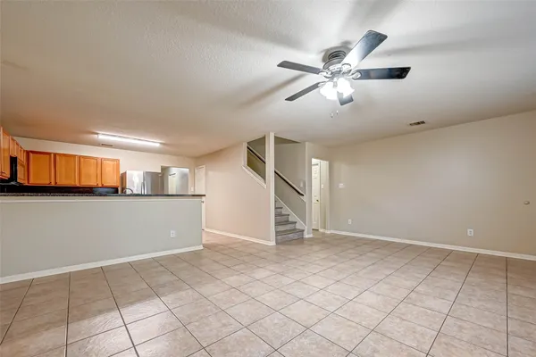 a view of a livingroom with a ceiling fan and window