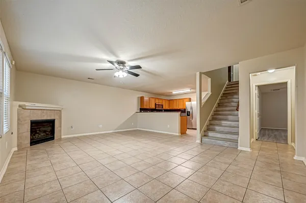 a view of a livingroom with wooden floor and staircase
