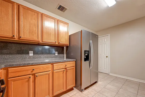 a kitchen with stainless steel appliances granite countertop a refrigerator and cabinets