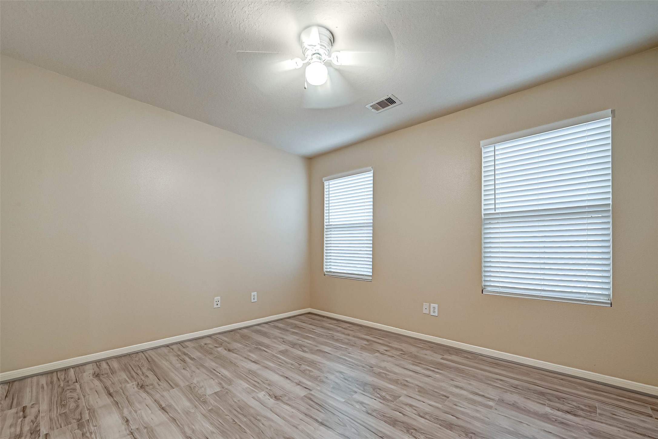 3522 Clipper Winds Way Houston, TX 77084 - Photo 23 of 48 an empty room with wooden floor and windows