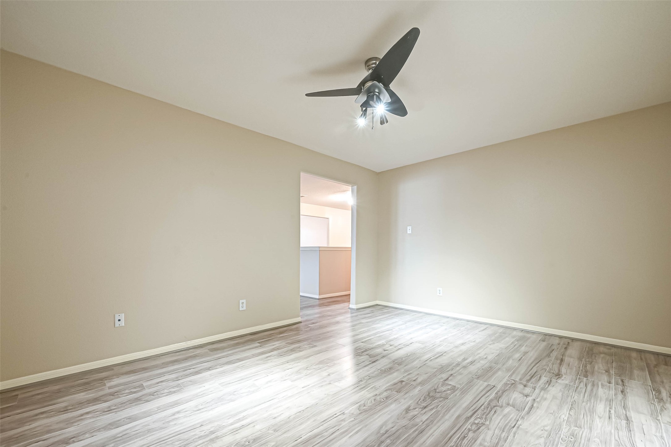 3522 Clipper Winds Way Houston, TX 77084 - Photo 25 of 48 an empty room with wooden floor and windows