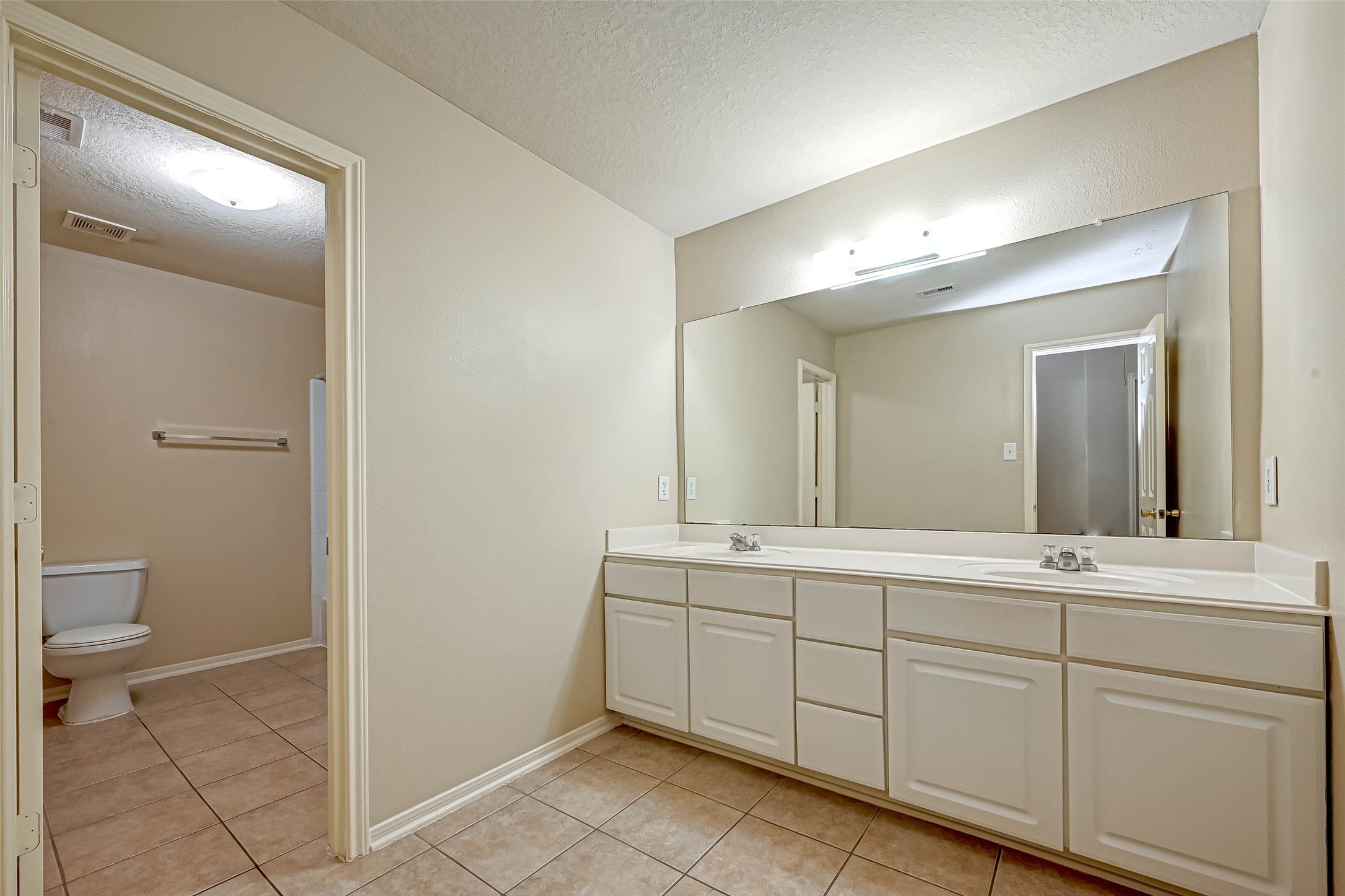 3522 Clipper Winds Way Houston, TX 77084 - Photo 27 of 48 a spacious bathroom with a toilet sink and a mirror