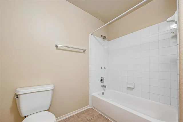 a bathroom with a toilet sink and shower
