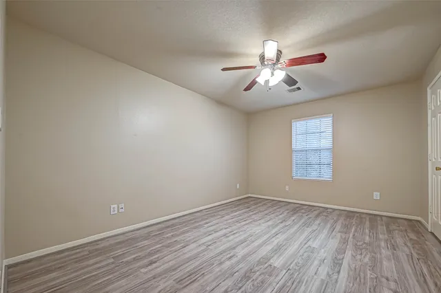 a view of a room with wooden floor and windows