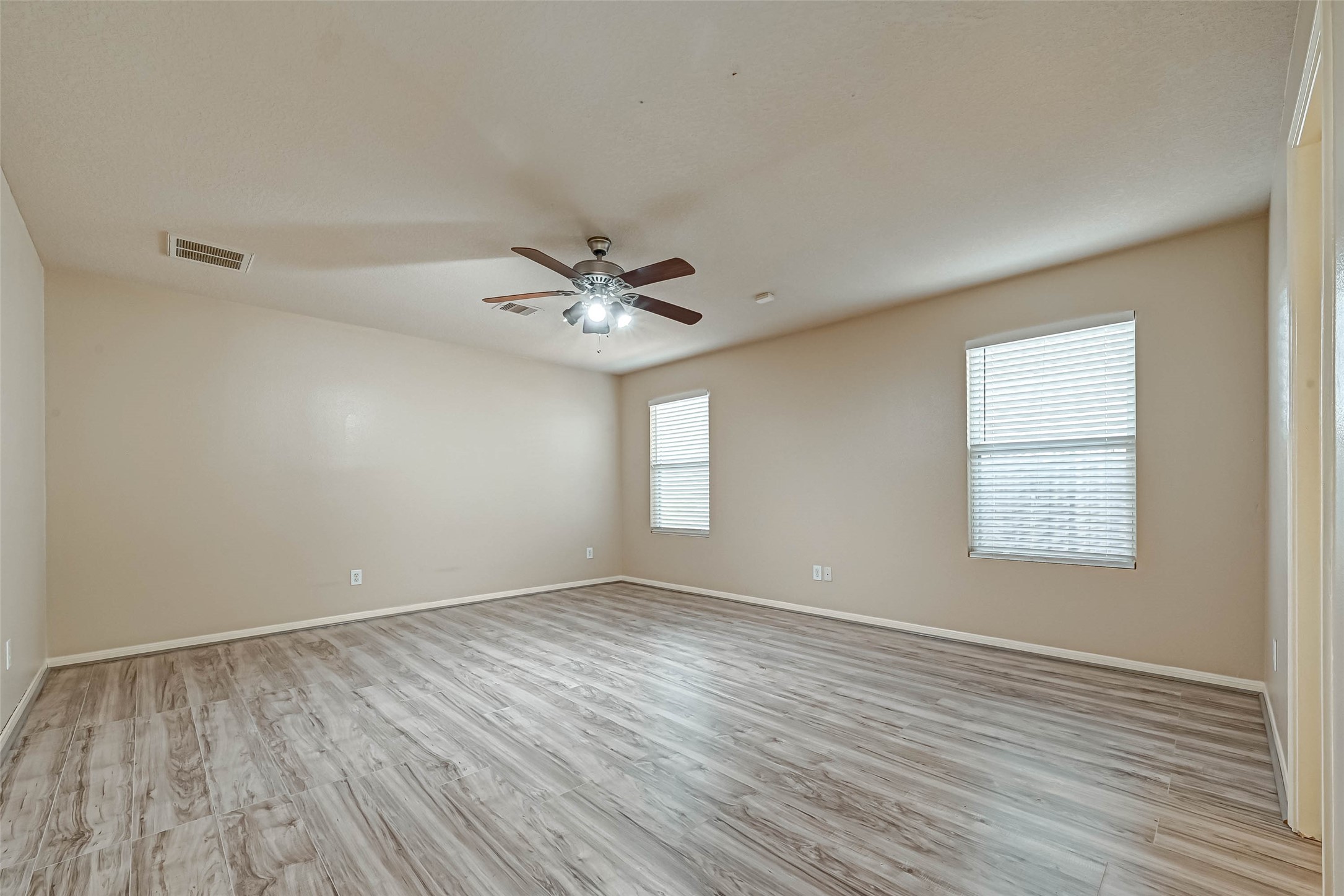 3522 Clipper Winds Way Houston, TX 77084 - Photo 33 of 48 a view of an empty room with wooden floor and a window