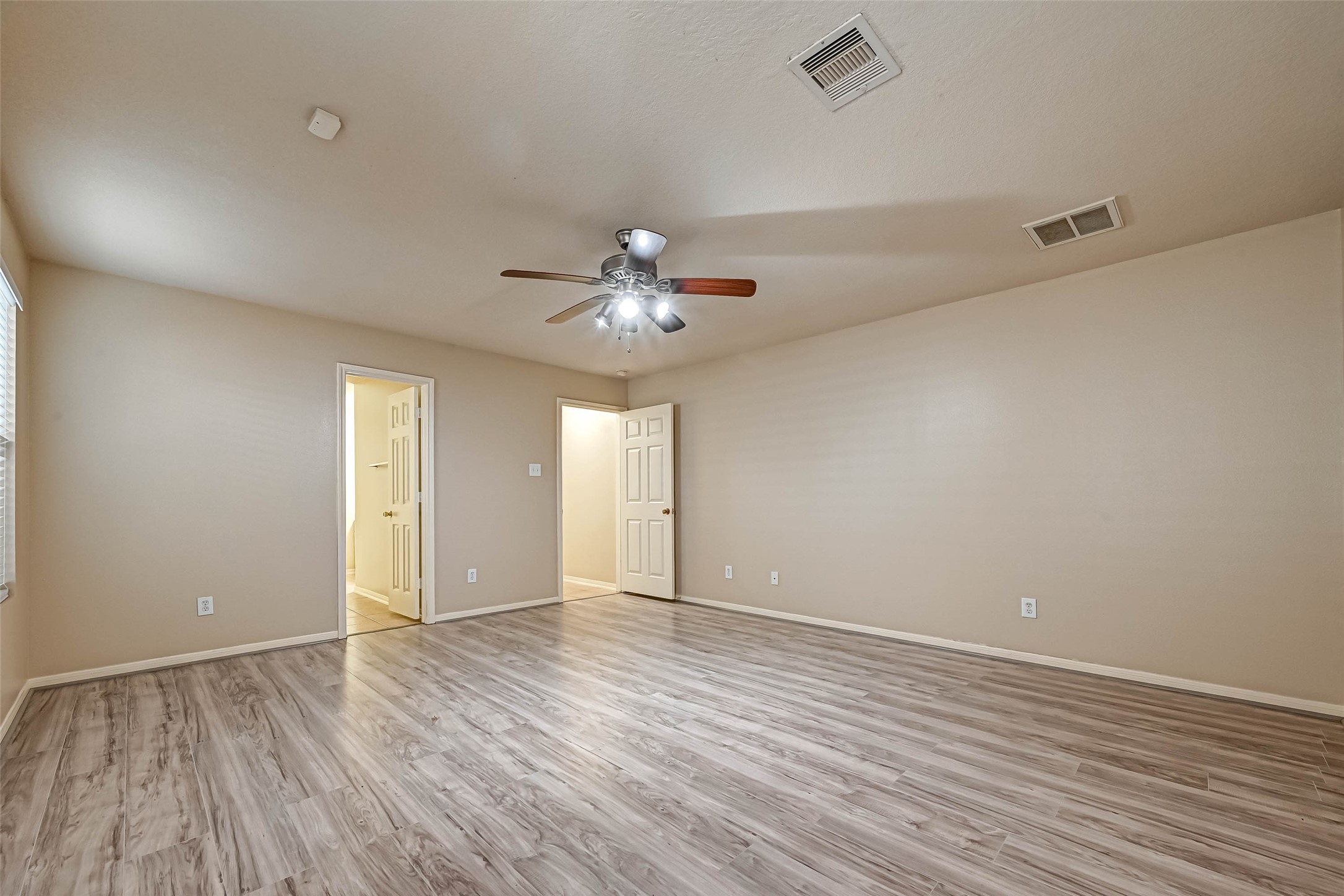 3522 Clipper Winds Way Houston, TX 77084 - Photo 35 of 48 wooden floor in an empty room with a window