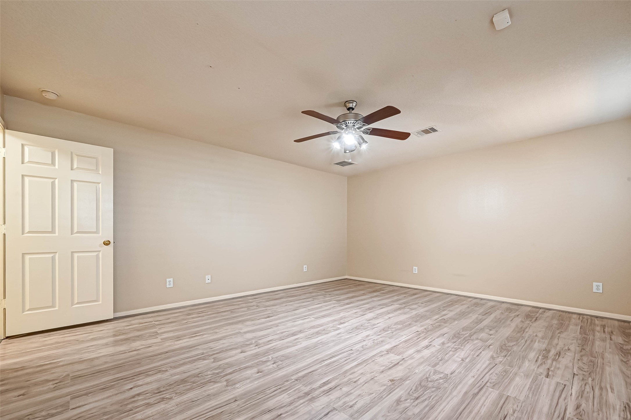 3522 Clipper Winds Way Houston, TX 77084 - Photo 36 of 48 an empty room with wooden floor chandelier fan and windows
