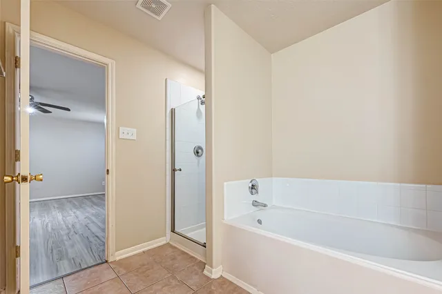 a bathroom with a bathtub and a shower