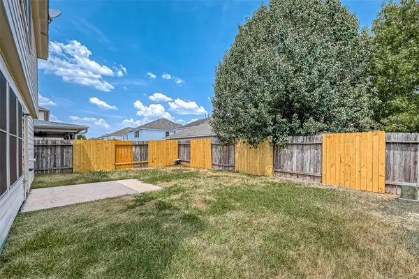 a view of a house with a yard and garage