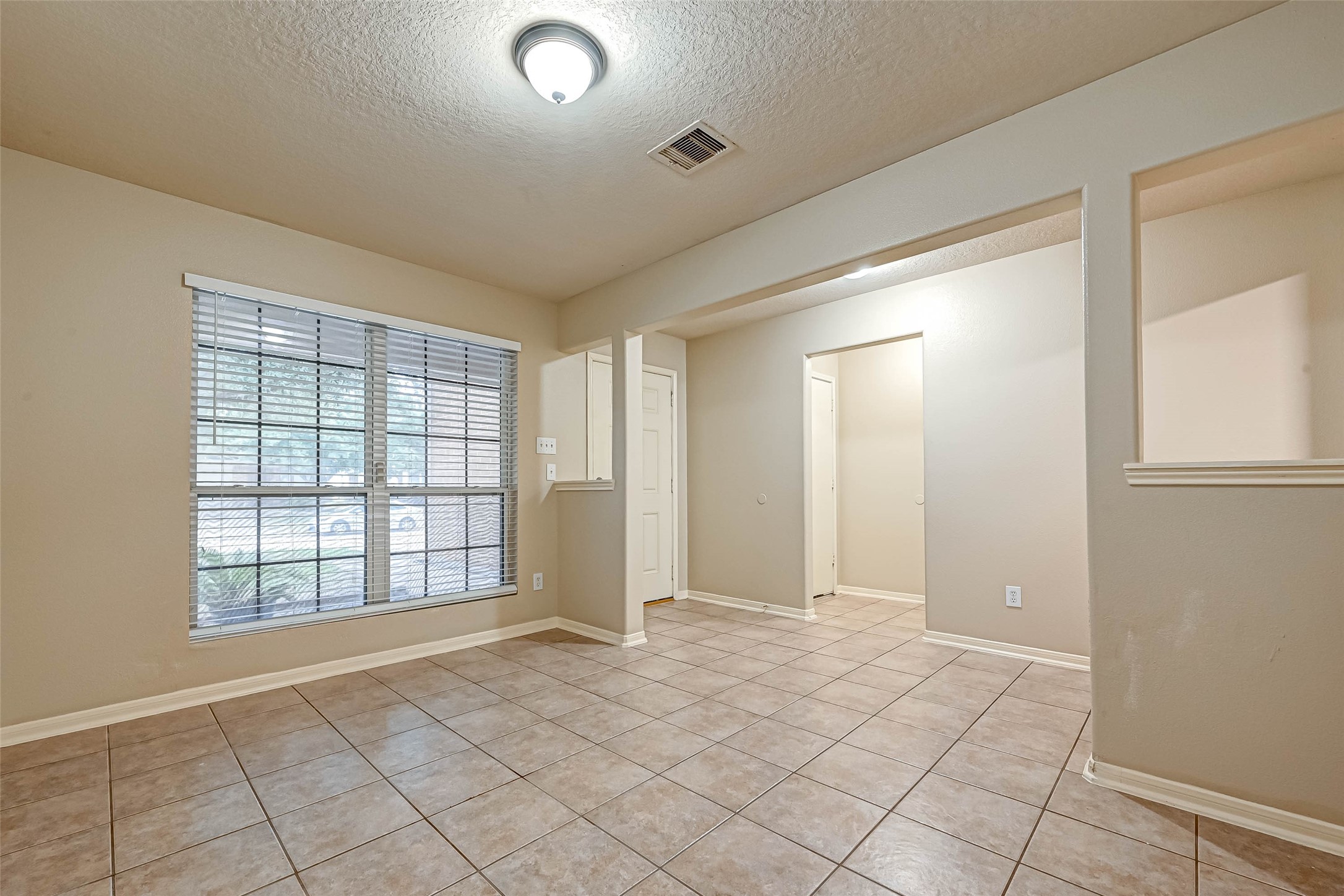 3522 Clipper Winds Way Houston, TX 77084 - Photo 10 of 48 a view of an empty room with window and chandelier fan