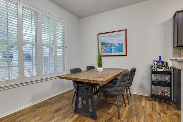 a view of a dining room with furniture and a kitchen