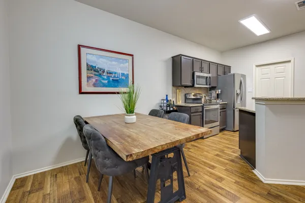 a kitchen with stainless steel appliances a refrigerator sink and stove