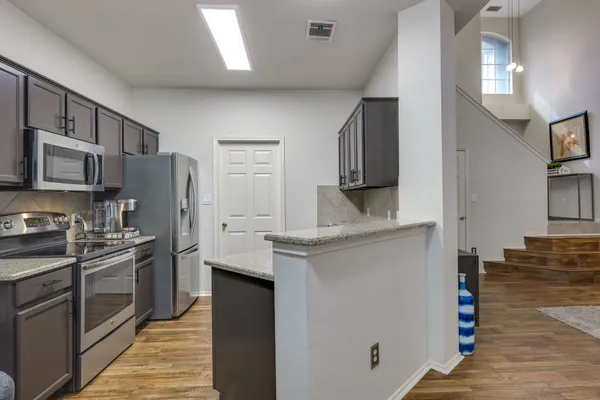 a kitchen with a refrigerator sink and microwave