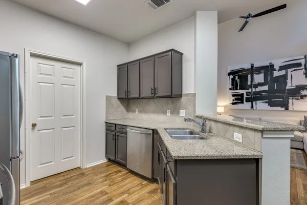 a kitchen with a sink and cabinets