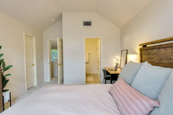 a bathroom with a granite countertop sink and a mirror with toilet