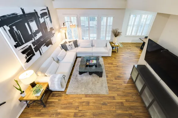 a living room with furniture ceiling fan and a window