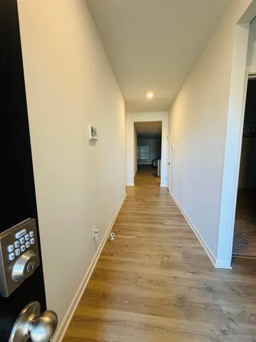 a view of a hallway with wooden floor