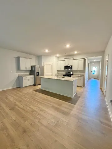 a view of an empty room and wooden floor