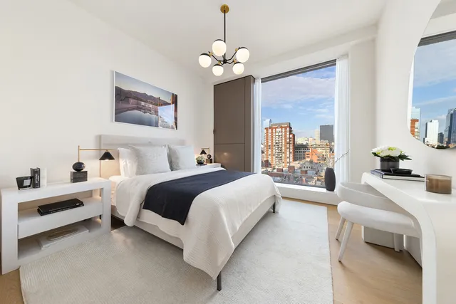 a large white room with a large window and double vanity