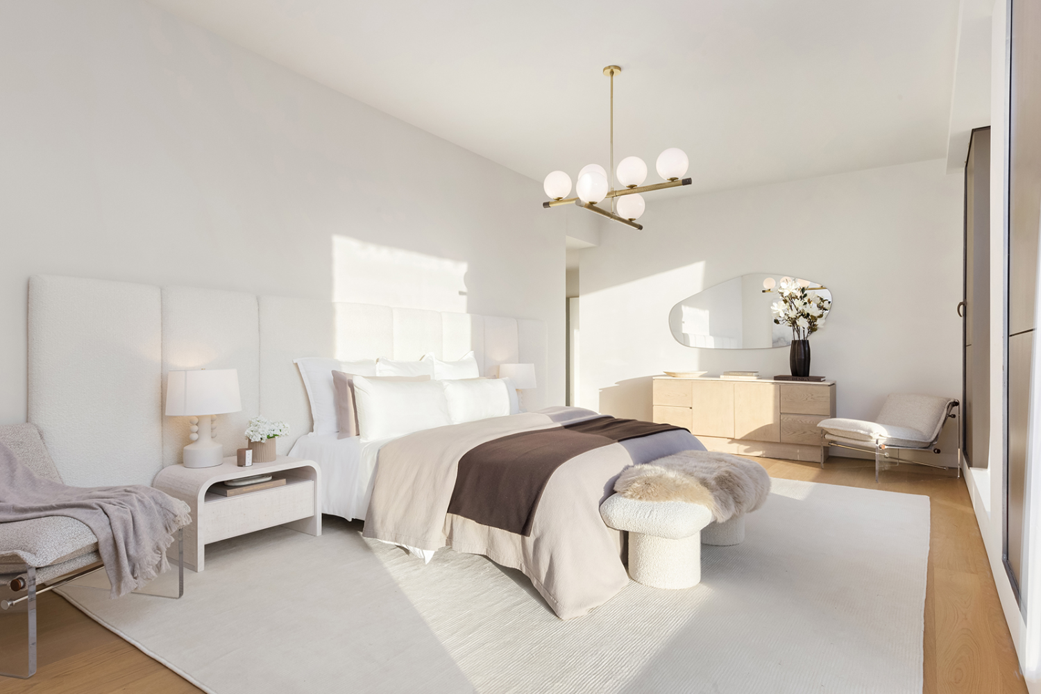 251 West 14th Street, Unit PH Manhattan, NY 10011 - Photo 8 of 13 a spacious bedroom with a bed couch chandelier and a window