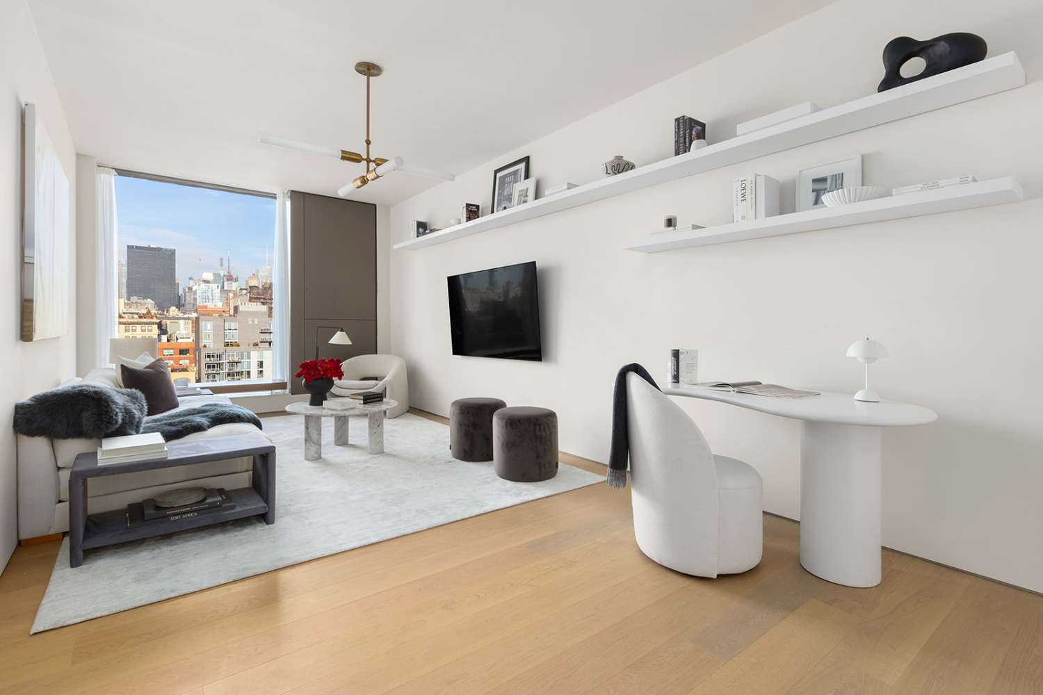 251 West 14th Street, Unit PH Manhattan, NY 10011 - Photo 9 of 13 a living room with furniture and a flat screen tv