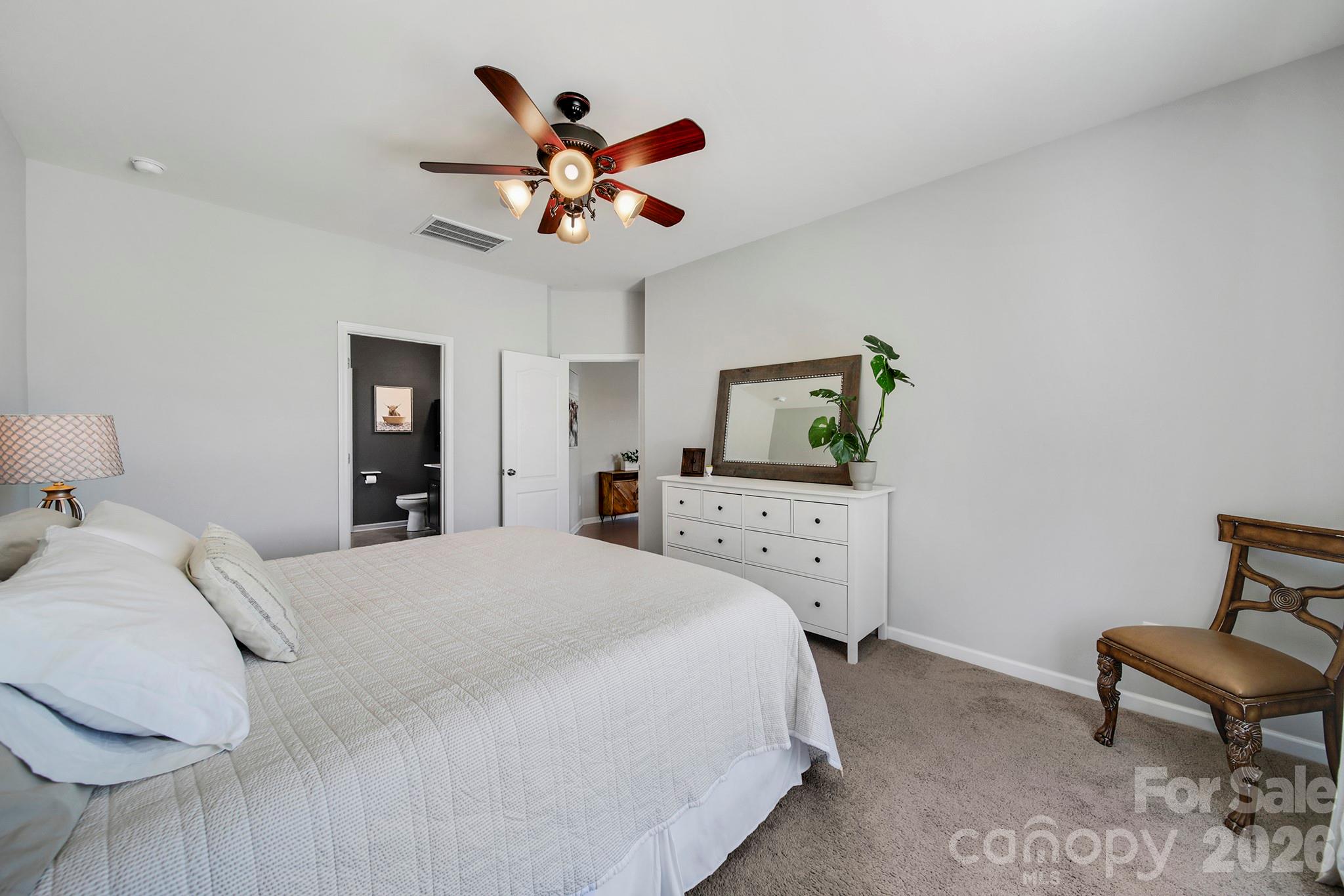 2217 Attaran Lane Lancaster, SC 29720 - Photo 12 of 25 a bedroom with a bed and a chandelier