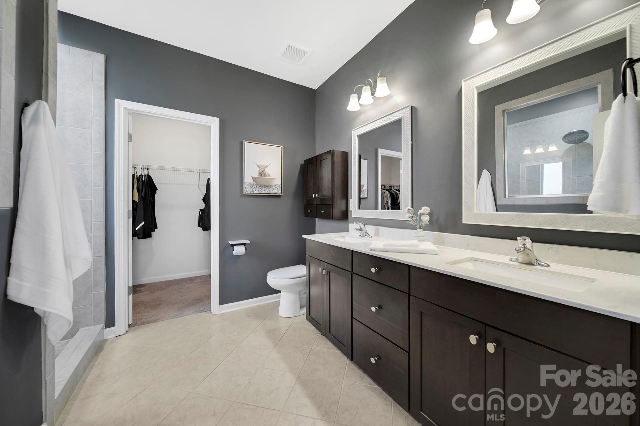 2217 Attaran Lane Lancaster, SC 29720 - Photo 13 of 25 a spacious bathroom with a double vanity sink a large mirror and a shower