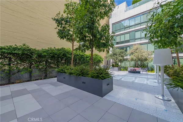 a lobby with furniture and potted plants