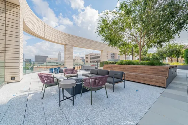 a view of a dining room with furniture a chandelier and wooden floor
