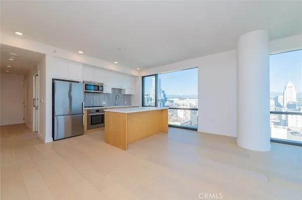 a kitchen with granite countertop white cabinets and stainless steel appliances