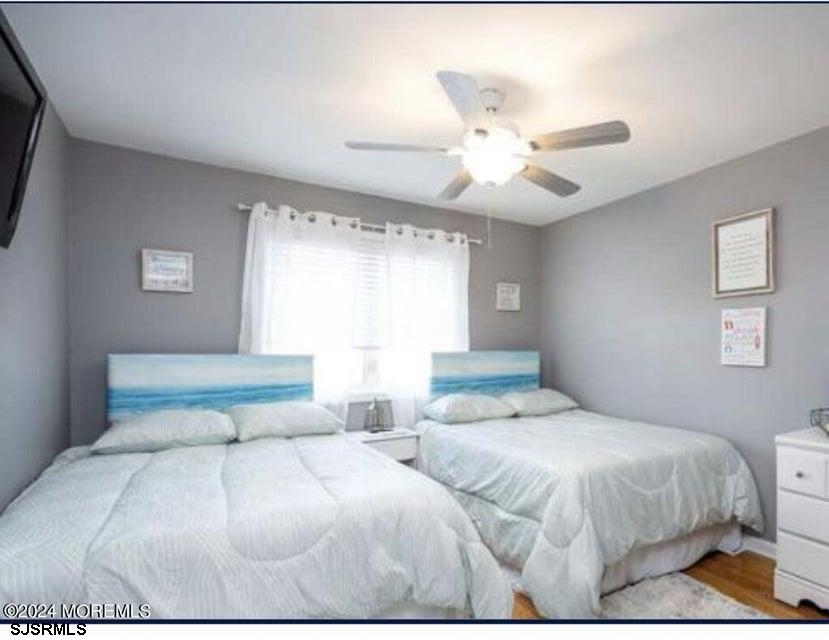 113 Marlin Road Tuckerton, NJ 08087 - Photo 5 of 14 a bedroom with a large bed and a chandelier