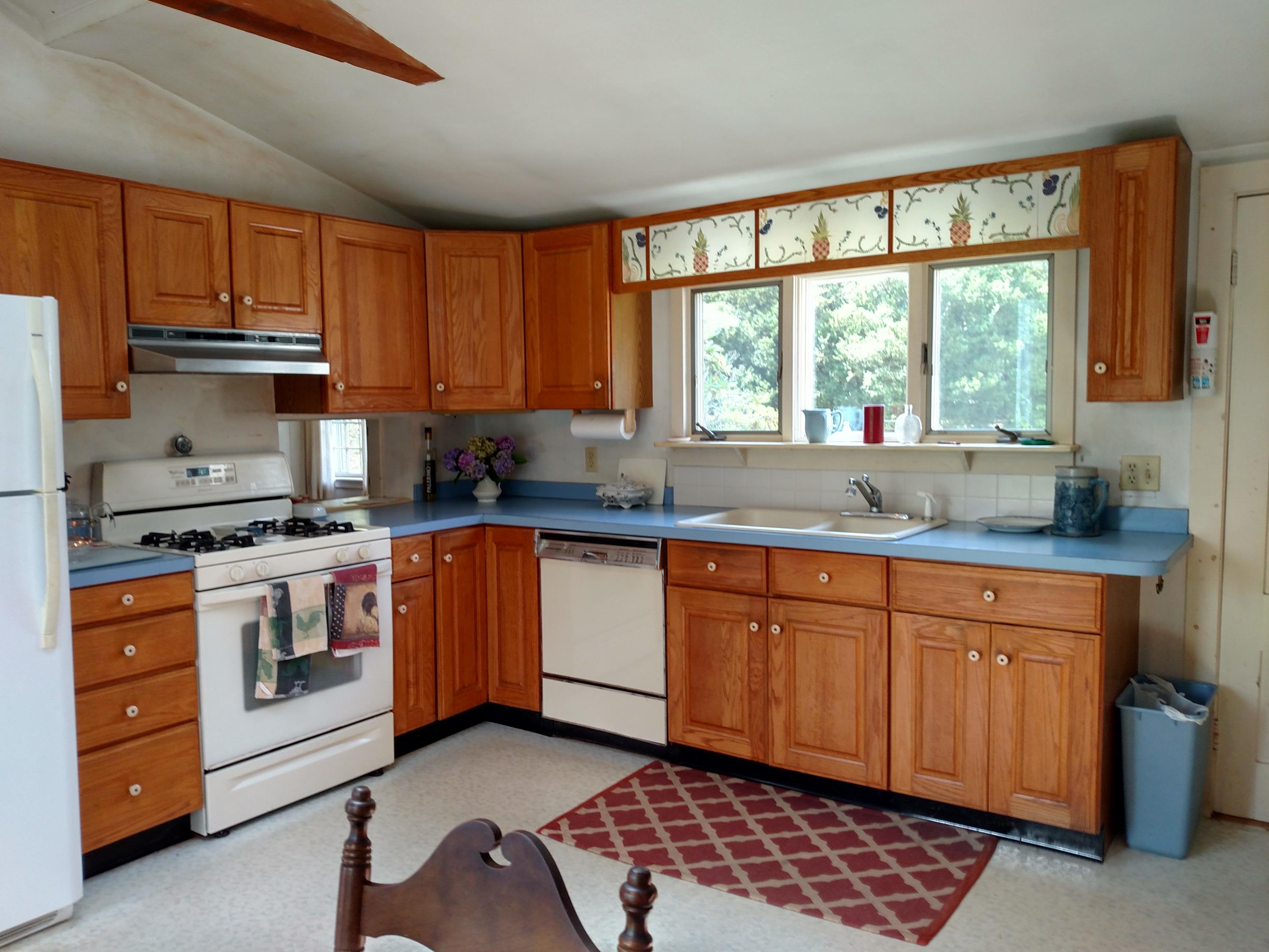 105 Spring Hill Road East Sandwich, MA 02537 - Photo 12 of 33 a kitchen with stainless steel appliances granite countertop a stove a sink and a microwave