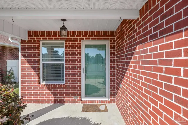 a view of an empty room with a kitchen and wooden floor