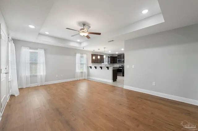 a view of an empty room with kitchen appliances