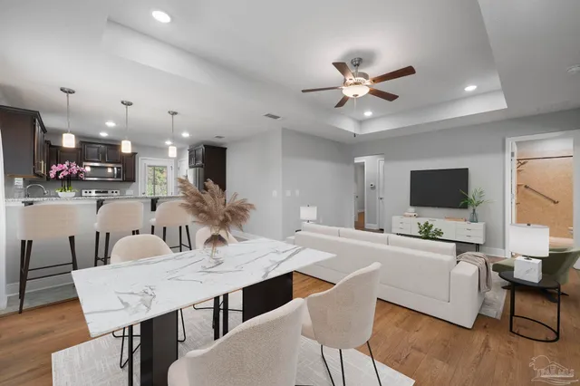 a view of a dining room with furniture and wooden floor