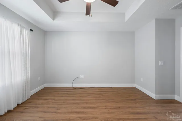 a bathroom with a granite countertop sink a light fixture and a mirror