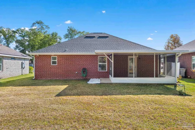 a backyard of a house with table and chairs