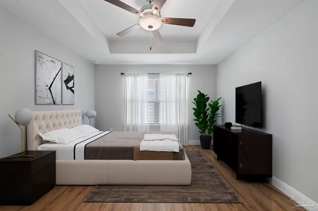 a bedroom with a bed and a flat screen tv