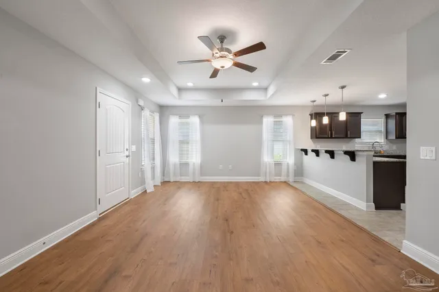 a view of a kitchen with a sink and wooden floor