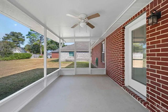 a view of a porch with wooden floor and fence