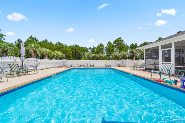 a view of yard with swimming pool and outdoor seating