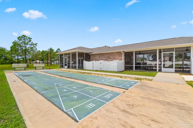 a view of a swimming pool with an outdoor seating and a garden