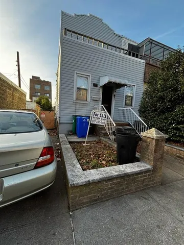 a front view of a house with barbeque grill
