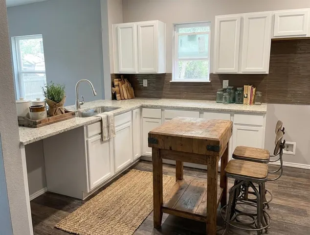 a kitchen with a sink cabinets and window