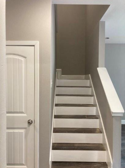 809 South Travis Avenue Denison, TX 75021 - Photo 7 of 13 a view of staircase with white walls and white door